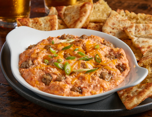 Pimento cheese and sausage dip plate with pita bread