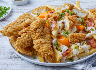 Loaded fries topped with chicken tenders, bacon, cheese curds, sauce, and scallions