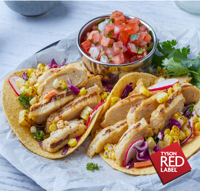 Two chicken tacos with corn and  pico salsa on the side