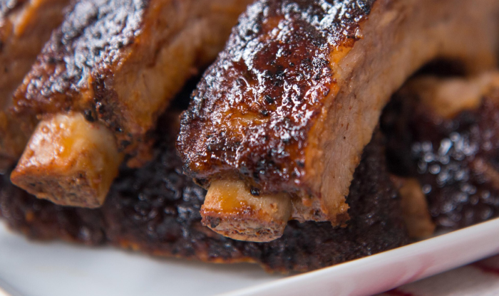 Close-up of BBQ ribs with caramelized glaze, showcasing tender, juicy meat