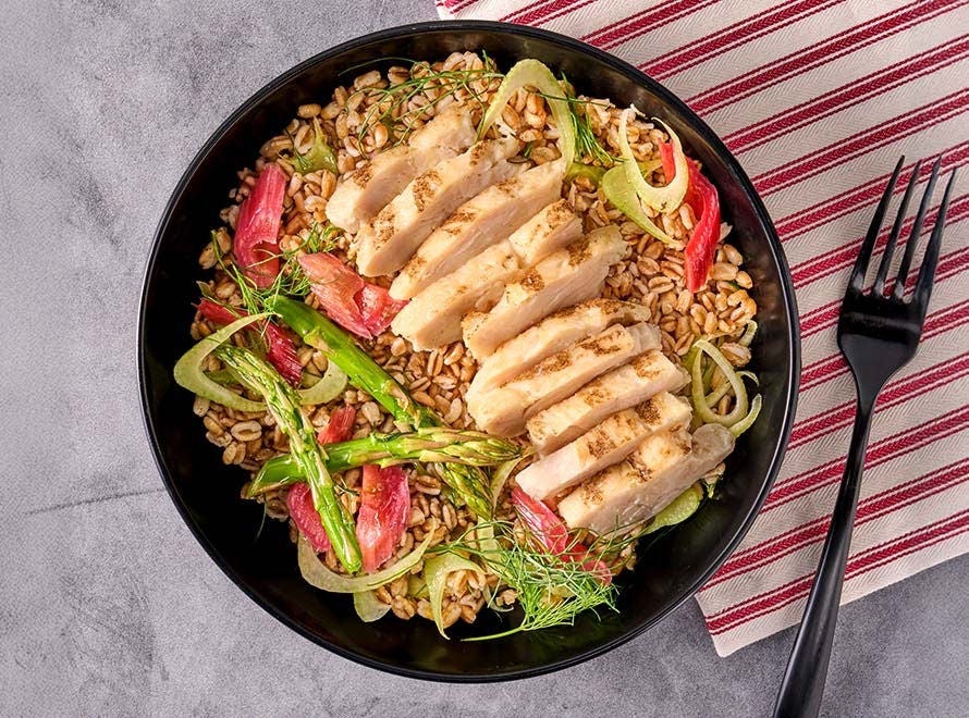 grilled chicken breast on bed of farro and fennel with asparagus tips and rhubarb