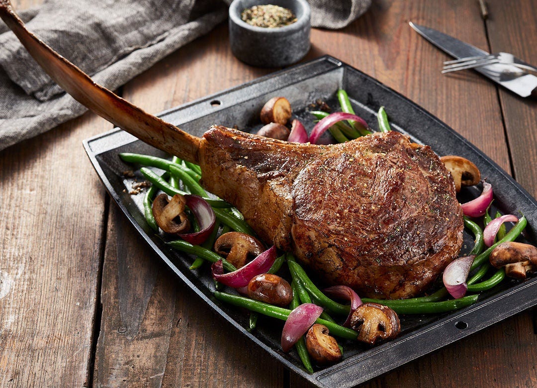 Tomahawk Steak menu item in restaurant setting