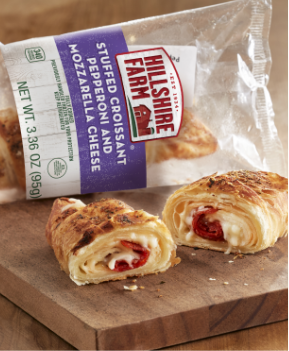 Pepperoni and mozzarella cheese stuffed croissant on a cutting board