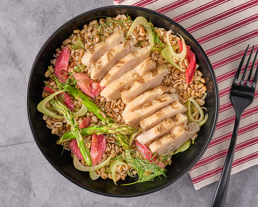 meal of farro, shaved green fennel, pink pickled rhubarb slices and grilled chicken