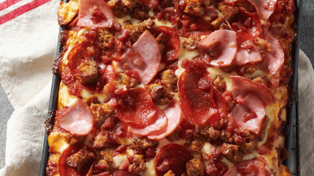 pizza toppings on a square dish pizza.