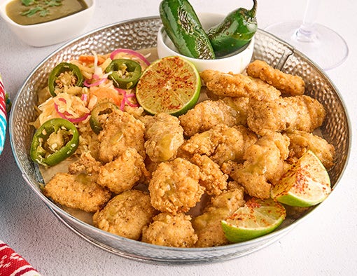 Crispy boneless wings drizzled with jalapeño lime butter, served with Salvadoran-style slaw