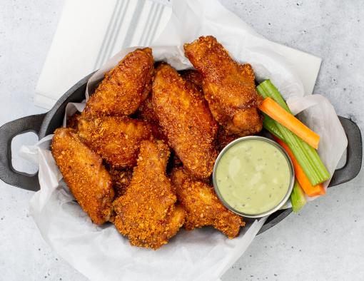 Applewood Smoked Wings with a side of green goddess ranch, carrots, and celery