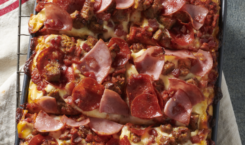pizza toppings on a square dish pizza.