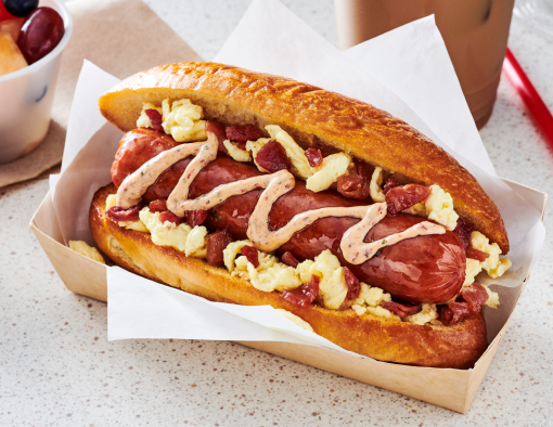Breakfast Dog topped with scrambled egg, bacon peices and chipotle aioli
