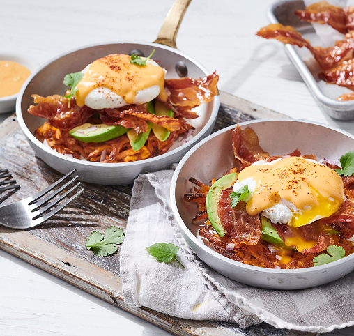 A twist on an English muffin eggs benedict made with sweet potato waffle fries in a bowl.