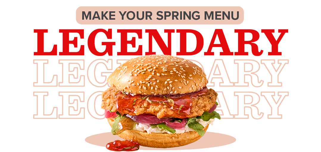 crispy chicken sandwich on sesame seed bun overflowing with ingredients and sauce