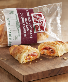 Ham and Cheese stuffed croissant on a cutting board