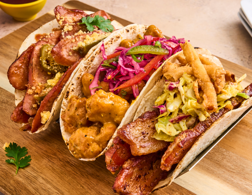 three different types of tacos with multiple dipping sauces