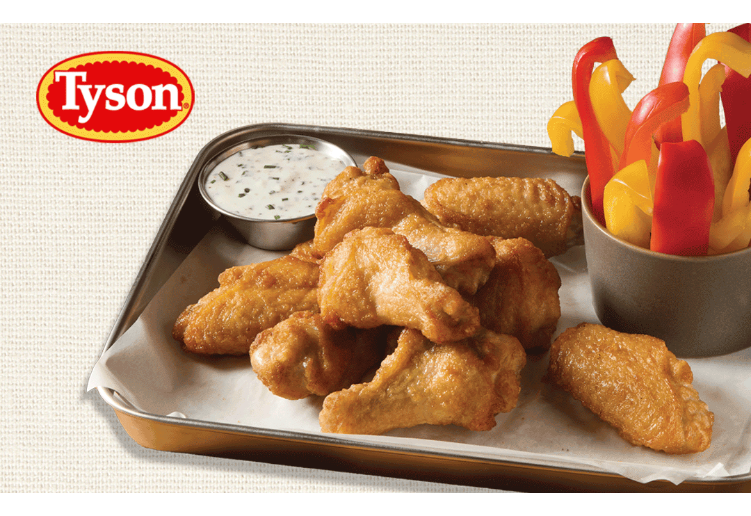 Tyson logo above a tray of golden bone-in chicken wings served with creamy dipping sauce and sliced red and yellow bell peppers