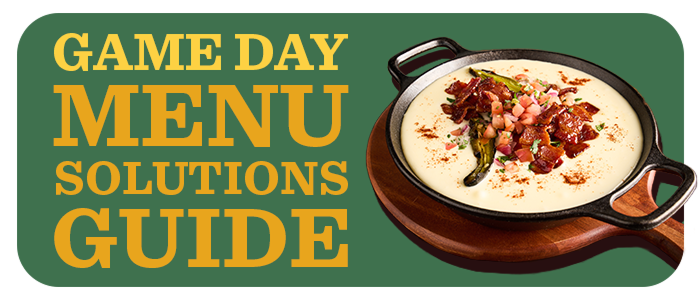 Overhead view of creamy queso dip loaded with bacon, pico de gallo, and jalapeños
