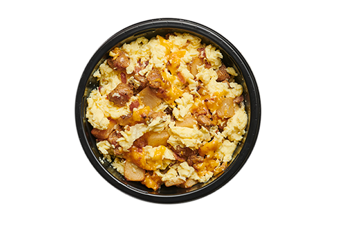 A breakfast bowl with eggs, cheese and sausage