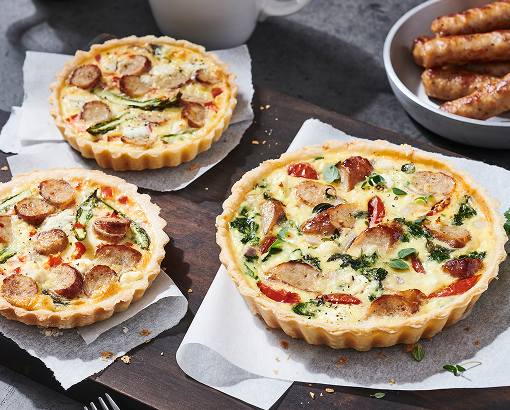 A breakfast tart made with pork sausage, fresh asparagus, eggs, goat cheese and red pepper