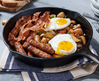 Breakfast skillet with bacon, sausage, potatoes and eggs.