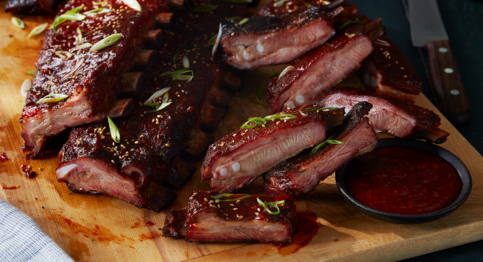 sauced barbecue ribs featuring a gochujang, ginger, sweet heat and pepper glaze