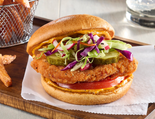 Spicy Hot Chicken Sandwich with Harissa Rainbow Slaw on parchment paper