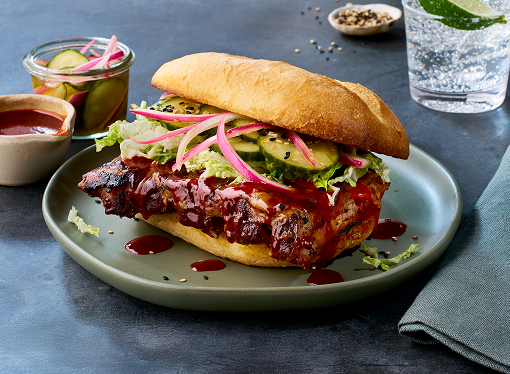 A pork rib marinated in rich bulgogi sauce served on a soft French roll with gochujang sauce and additional toppings