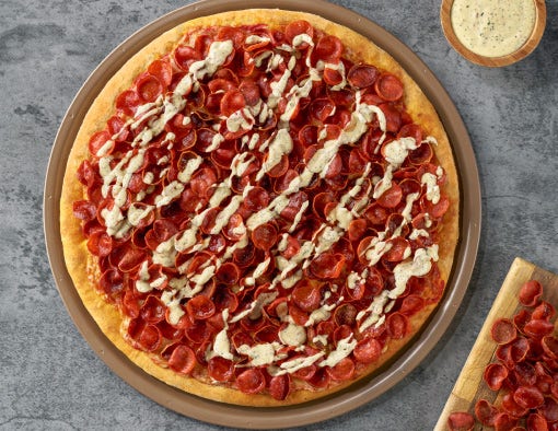 large pizza overloaded with Cupping Pepperoni topped with crispy cupping pepperoni chips and drizzled with a toasted celeroni ranch