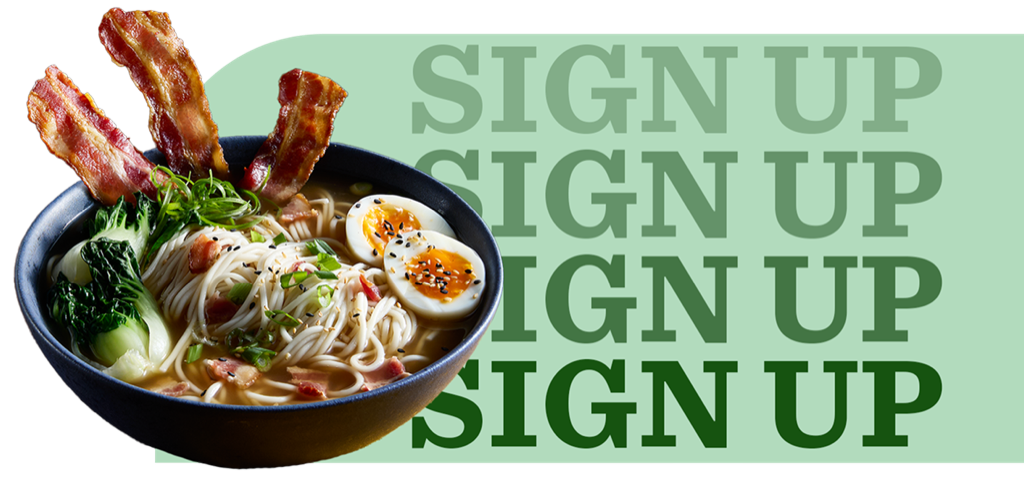 Ramen noodles, bacon, soft-boiled eggs and baby bok choy in a bowl of clear broth