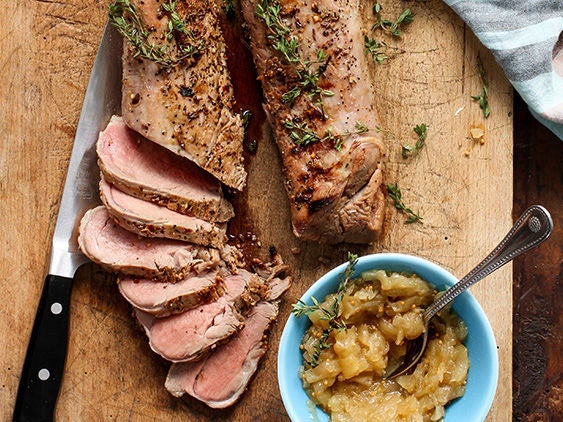 Grilled and Sliced Pork Tenderloin with Apple Onion Jam on a Board.