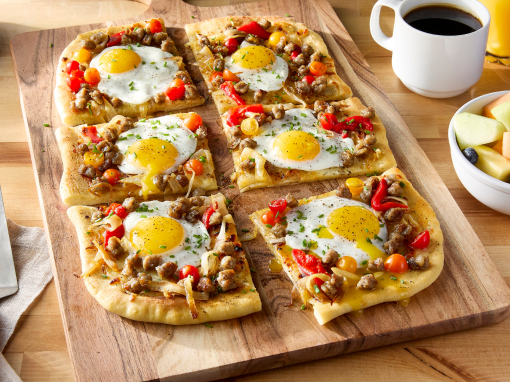 Sunny Side up egg pizza with a side of fruit and coffee