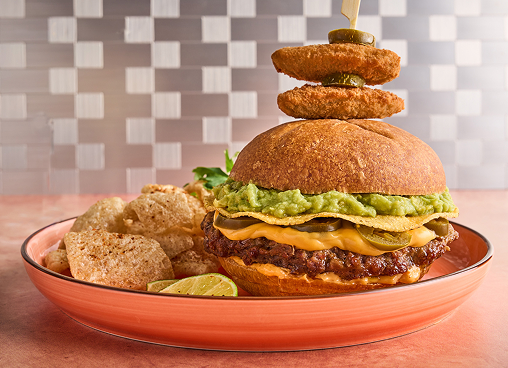 A cheeseburger on a red/orange plate