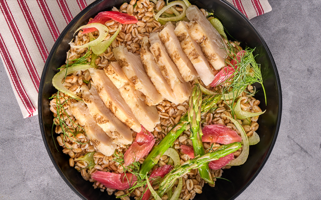 meal made of farro/barley grains, sliced grilled chicken, rhubarb slices, asparagus pieces and other herbs