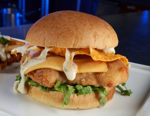 Loaded Crispy Chicken Nacho Sandwich with a side of fries