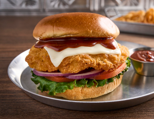 Spicy Maple Chicken Sandwich on a metal plate with sauce